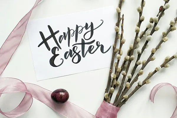 An Easter Sunday card with a chocolate egg and flowers